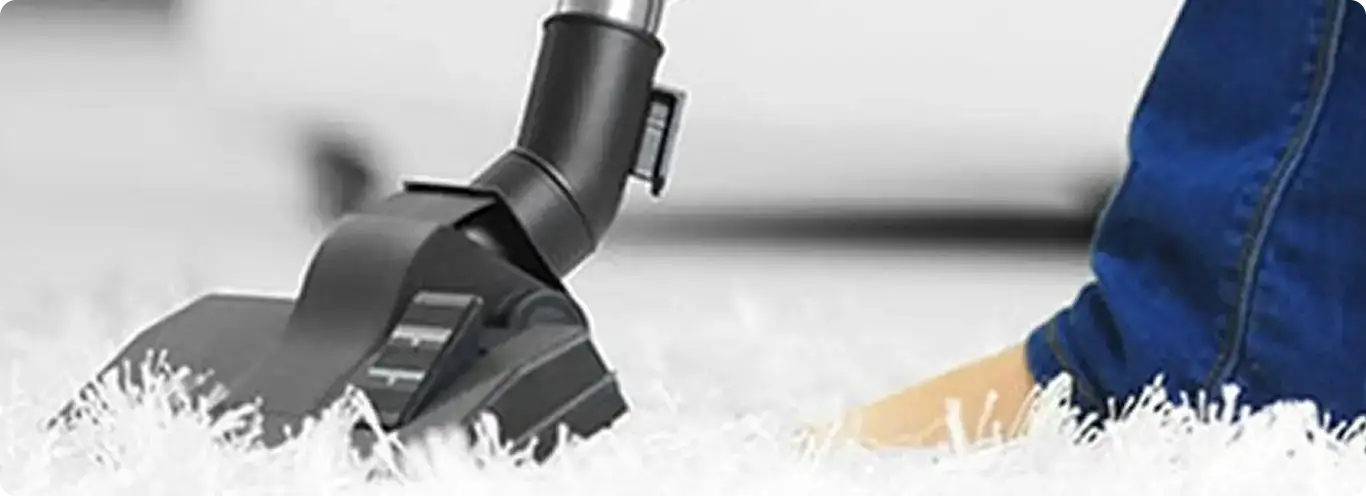 Close-up of a professional vacuuming a white carpet in Republic.